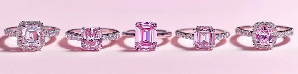 Engagement Rings 1 Five diamond engagement ring styles in a row, including halo and solitaire settings, on a light pink background