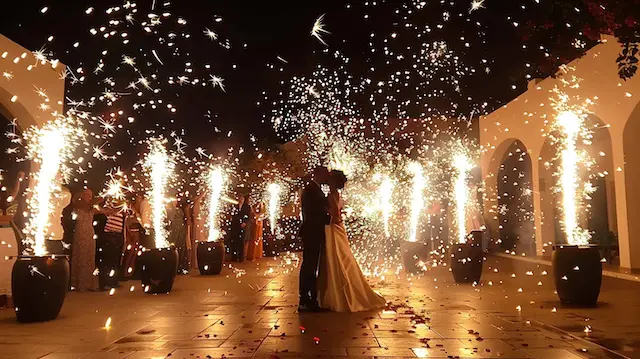 a couple kissing under fireworks