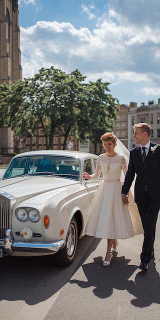 classic white rolls royce picking up newlyweds