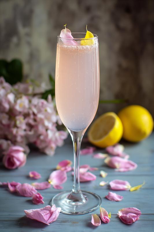 champagne flute with Blush Gin Fizz with gin, elderflower, lemon, soda, and rose petal garnish—light and floral for spring weddings champagne flute with Blush Gin Fizz with gin, elderflower, lemon, soda, and rose petal garnish—light and floral for spring weddings