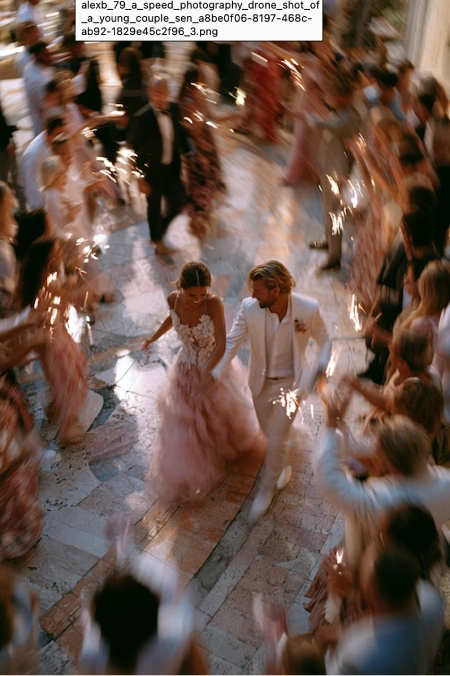 Why Weddings Go Over Budget (And Exactly Where the Money Goes) 6 Bride and groom make a sparkler exit through cheering guests during a lively wedding reception celebration.