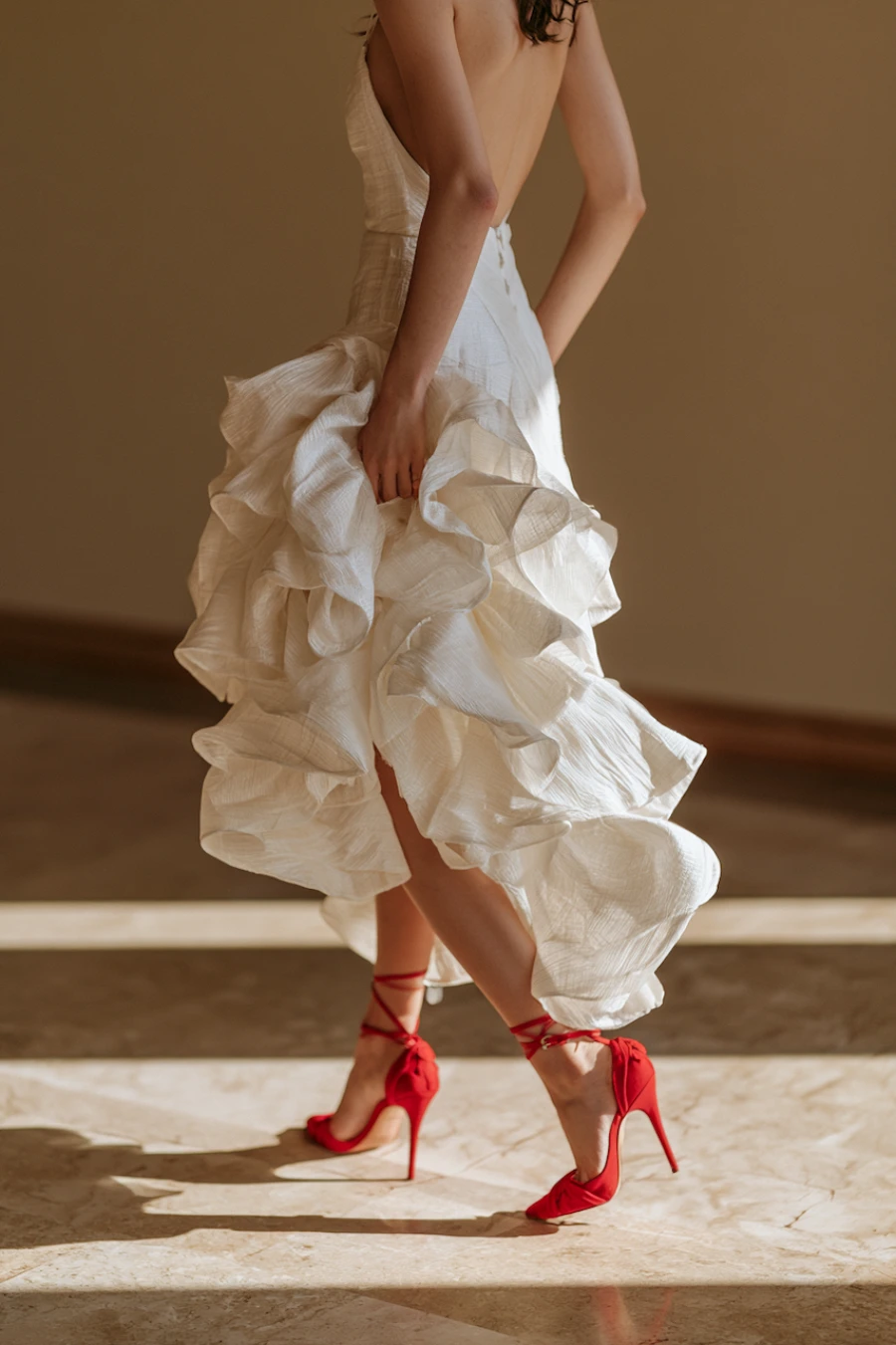 Wedding Shoes for the Bride: 27 Beautiful Ideas That Balance Style and Comfort 21 Bride in flowing ivory wedding dress wearing bold red ankle tie stilettos, creating a dramatic bridal fashion statement