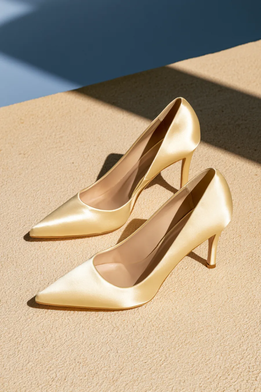 Wedding Shoes for the Bride: 27 Beautiful Ideas That Balance Style and Comfort 23 Classic ivory satin wedding pumps with pointed toes and mid-height heels in warm sunlight for timeless bridal elegance