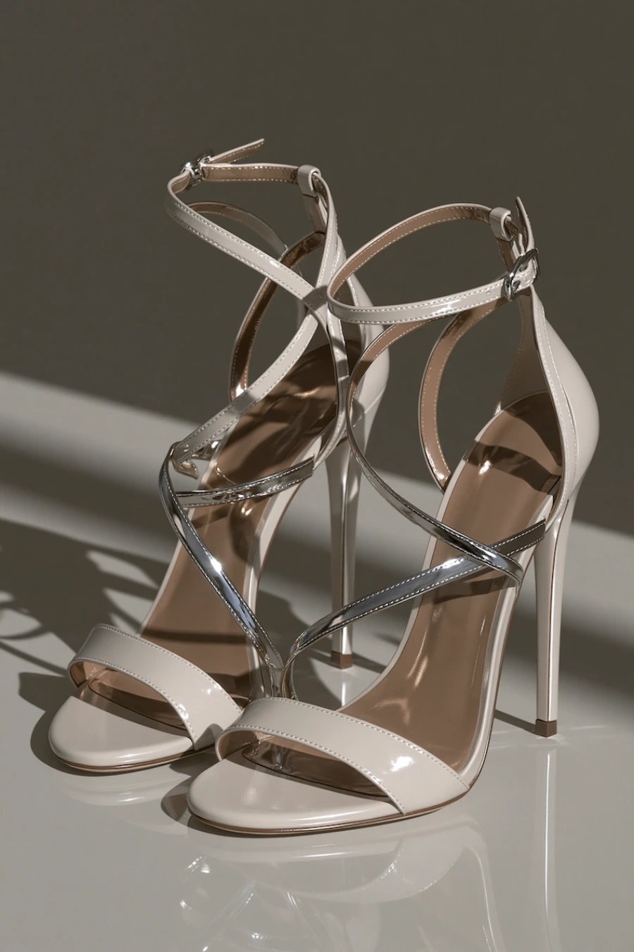 Wedding Shoes for the Bride: 27 Beautiful Ideas That Balance Style and Comfort 7 Ivory bridal sandals with metallic crossover straps, ankle buckles, and slim stiletto heels in a luxury studio setting