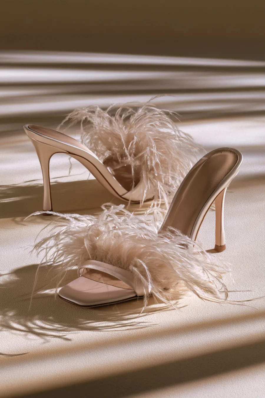 Wedding Shoes for the Bride: 27 Beautiful Ideas That Balance Style and Comfort 25 Ivory feather bridal mule heels with open square toes and slim stilettos in warm light for glamorous wedding reception style