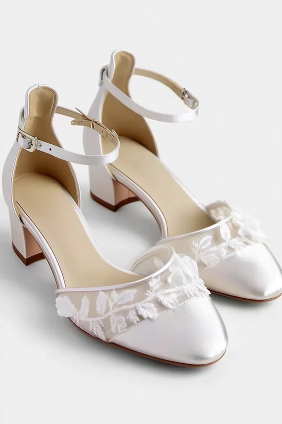 Wedding Shoes for the Bride: 27 Beautiful Ideas That Balance Style and Comfort 14 Ivory lace wedding shoes with low block heels, ankle straps, sheer floral embroidery, and pointed toes on white background