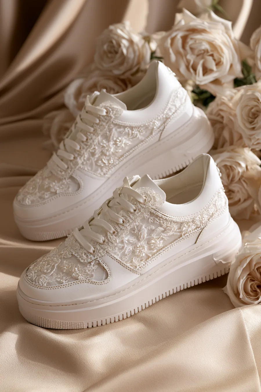 Wedding Shoes for the Bride: 27 Beautiful Ideas That Balance Style and Comfort 17 White lace bridal sneakers with floral embroidery and chunky soles styled on satin beside ivory roses for wedding day comfort